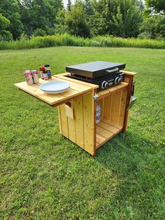 an outdoor grill is set up in the grass