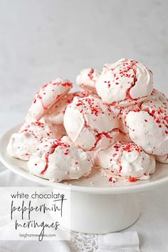 white chocolate peppermint meringies in a bowl with red sprinkles