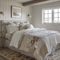 a bedroom with white walls and wooden floors