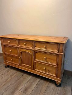 a wooden dresser sitting on top of a hard wood floor