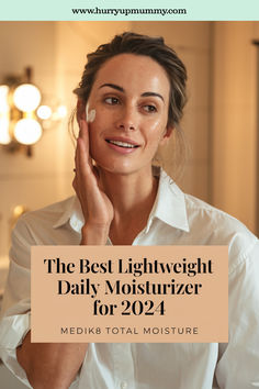 A woman applying a daily facial cream to her face in a softly lit bathroom, highlighting the benefits of Medik8 Total Moisture for a lightweight skincare routine. Daily Moisturizer, Facial