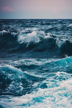 the ocean is full of waves as it breaks and begins to break into the water