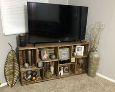 an entertainment center with a flat screen tv and decorative items