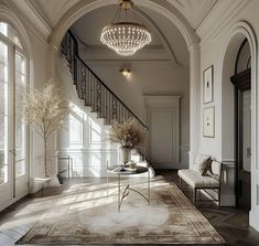 a living room with an arched doorway and chandelier hanging from the ceiling above it