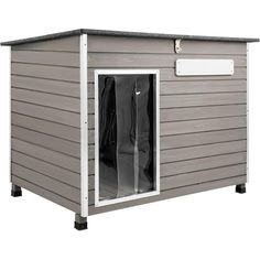 a gray storage shed with the door open and clothes hanging on it's side