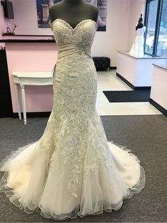 a wedding dress on display in a store