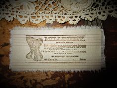 an old piece of cloth with lace on it and a label that says millinery