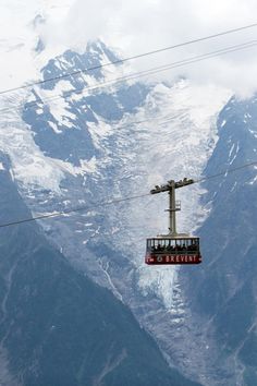 the cable car is suspended above the snowy mountains