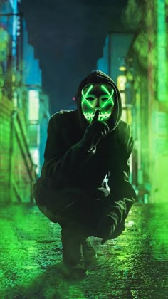 a person in a neon mask crouching down