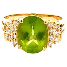 Item Specifications: Style: Statement ring Metal: 18k Yellow Gold Ring Weight: 4.90 grams Ring Size: 7 Ring Height: 10.86 mm Gemstone Specifications: Gemstone: Peridot Topaz Measurements: 10.82 mm x 8.84 mm x 5.56 Topaz Carat Weight: ~3.36 Carats Color: Lime Green Shape: Oval Transparency: Transparent Diamond Count: 14 diamonds Diamond Weight: 0.15 carats Diamond Color: H Diamond Clarity: SI2 Condition: Preowned, Excellent Stamped: "18K" "750" Please see all photos for details, feel free to ask 18k Yellow Gold Ring, Ring Metal, Yellow Gold Ring, Ring Size 7, Diamond Clarity, Yellow Gold Rings, Metal Rings, Statement Ring, Colored Diamonds