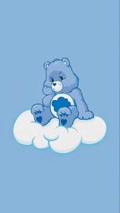 a blue teddy bear sitting on top of a cloud