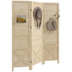 a room divider made out of wood with hooks on the side and a bag hanging from it