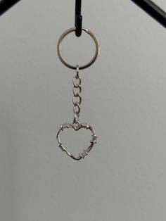 a heart shaped key chain hanging from a hook