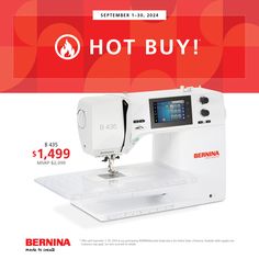 a white sewing machine sitting on top of a table next to a red sign that says hot buy