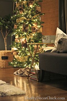 a living room with a christmas tree in the corner, and a couch next to it