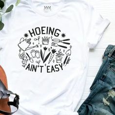 Gardener ,Farmer Or Plant Lover “ Hoeing Ain’t Easy” Gildan Cotton T-Shirt Nwt ($16 For Small,Medium And Large) Funny Plant Sayings, Plant Sayings, Plant Store, Gardening Shirts, Book Writing, Book Writing Tips, Simple Shirts, T-shirts & Tank Tops, Shirt Svg