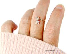 "This cute flower charm dangle ring has a sterling silver dainty flower, color of your choice, with Swarovski crystal rhinestones dangling from the sterling silver argentium band. ✦100% handcrafted ✦ High quality sterling silver and sterling silver argentium ✦ Arrives in a beautiful pink or white cotton-filled gift box with and tied with a pink or black bow and an optional complimentary pastel colored gift card ✦ Ready to ship in one business day ✦ Average shipping time (US/Canada/UK) three to f Delicate Cubic Zirconia Flower Ring For Gifts, Dainty Birthstone Flower Ring For Anniversary, Dainty Flower Ring With Birthstone For Anniversary, Delicate Flower Birthstone Promise Ring, Adjustable Birthstone Flower Ring For Anniversary, Adjustable Flower Ring With Birthstone For Anniversary, Diamond Flower Ring With Birthstone As A Gift, Personalized Dainty Flower Ring, Sterling Silver Flower Ring With Birthstone For Gift