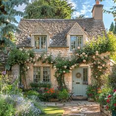 an old stone house with roses growing on it