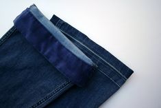 a pair of blue jeans laying on top of each other