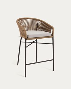 an outdoor chair with a cushion on the seat and backrest, made out of wicker