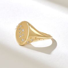 Elevate your style with the Diamond Celestial Signet Ring. This 14k solid gold flat dome ring for women features a stunning star and moon constellation design adorned with diamonds. The chunky design and celestial inspiration make it a unique and captivating piece. Choose from 18k or 10k gold for your preferred look. Features * Made to Order. * Gold KT: 10K, 14K, 18K * Custom Gold Color: Rose Gold, Yellow Gold, White Gold * Diamond Color- Clarity: D-E-F color VVS clarity (excellent ideal cut) * Total Ctw: 0.09 ctw * Width of Top: 12.50x8.20MM * Width of Band: 1.33MM * Thickness of Band: 0.80MM * Ready to Ship in 5-7 Business Days ✓ We care about the environment,the jewelry we cast is made with recycled gold. We source exclusively post-consumer material that is refined back to its pure elem Signet Rings Women Vintage Diamond, Unique Signet Ring, Moon Constellation, Celestial Inspiration, Pinky Rings For Women, Constellation Design, Pinky Signet Ring, Constellation Ring, Gold Pinky Ring