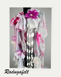 Wrap yourself in light, flowing elegance with this stunning boho-style scarf, a unique piece of wearable art. Crafted from two layers of white silk tulle--one plain and the other with a delicate floral pattern--this enchanting scarf is adorned with vintage Victorian lace, soft tulle, handmade flowers, and ribbons of silk, organza, and lace. Accentuated with velvet, glass beads, and intricate threads, it adds a whimsical, romantic touch to any outfit. Colors: White, shades of pink, cyclamen Dimen Pink Bohemian Shawl For Wedding, Bohemian Party Scarves For Spring, Bohemian Pink Shawl For Festivals, Pink Shawl For Festival, Bohemian Scarves For Weddings And Festivals, Pink Bohemian Scarf One Size, White Bohemian Scarf One Size, White Bohemian Shawl Dupatta, Bohemian Spring Festive Dupatta