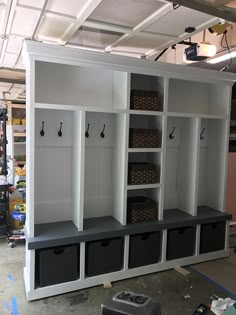 a room with several storage cabinets and bins