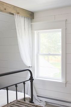 a bedroom with a metal bed frame and white walls