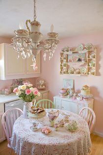 an old fashioned tea party with pink roses and white china on the table, in a kitchen