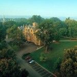 an aerial view of a large building surrounded by trees