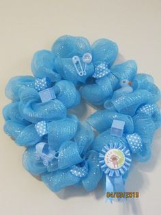 blue mesh wreath with baby items on it