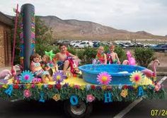 there is a float in the shape of a pool with people on it and flamingos