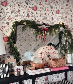 a shelf with christmas decorations and pictures on it