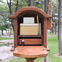 an old wooden mailbox with many boxes in it