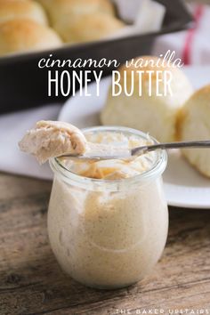 cinnamon vanilla honey butter in a glass jar with a spoon on the side and another plate behind it