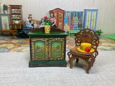 a doll house with furniture and dolls on the floor in front of it's display