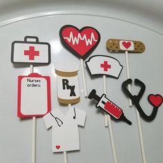 medical themed cupcake toppers are arranged on a cake plate for a nurse's day party