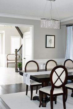 a dining room table with chairs and a chandelier