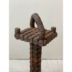 a sculpture made out of wooden logs and nuts