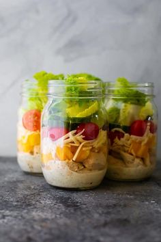 three mason jars filled with different types of food