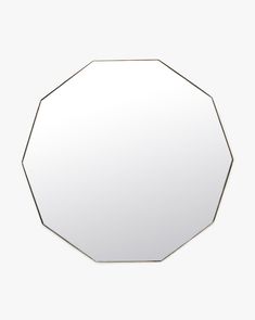 an octagonal mirror on a white wall