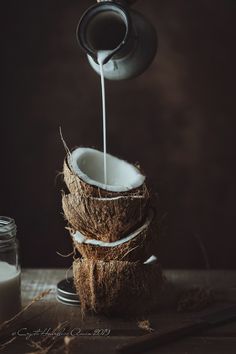 coconut milk being poured into a cup