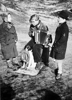 an old photo of three people playing the accordions with a dog sitting next to them