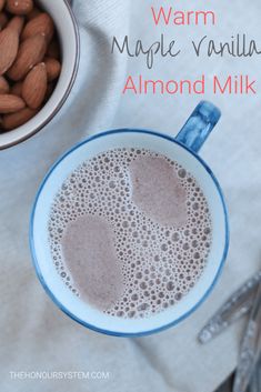 a cup of almond milk next to a bowl of almonds