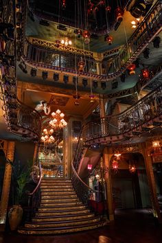 an ornate staircase with chandeliers and lights