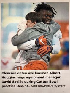 an ad for the cleveland defensive lineman albert hugins hugs equipment manager david saville during cotton bowl practice