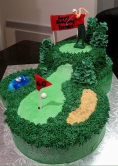 a golf themed birthday cake with a green course and red flag on the top,