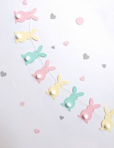 the bunnies are decorated with pastel colors and heart shaped confettis