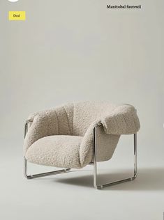 a chair that is sitting in the middle of a room with a white wall behind it