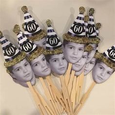 a group of people with hats on top of toothpicks in front of a wall